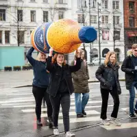 Large lightweight inflatable bottle carried by two people to demonstrate mobility